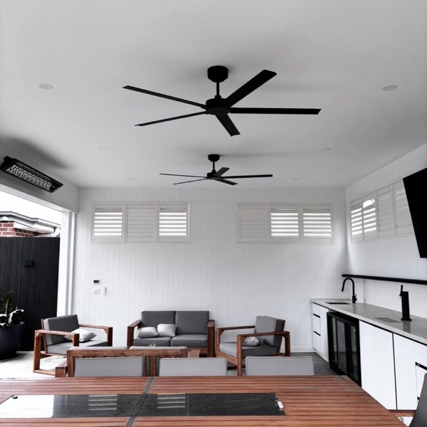 Ceiling fans and downlights above an outdoor dining setting