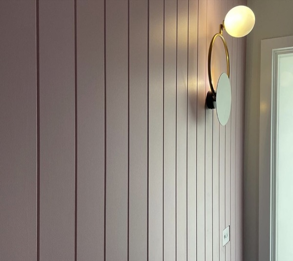 An exterior wall light mounted on vertical cladding