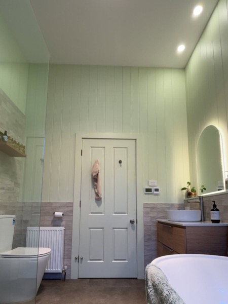 A bathroom with recessed ceiling lighting
