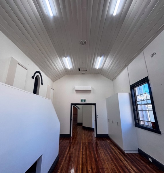 A corridor with ceiling lighting along its length