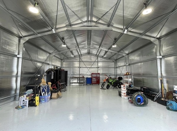 A large shed interior lit by rows of ceiling lights