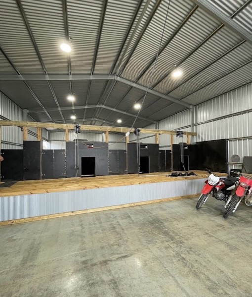 A shed interior with high ceiling lighting