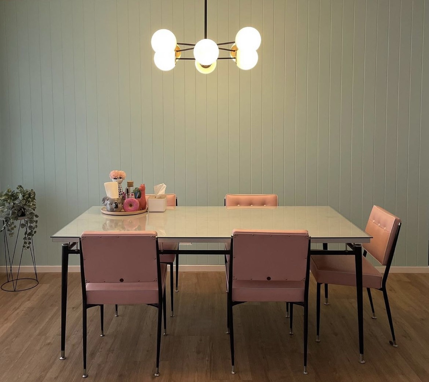 A dining room lit by a warm ceiling chandelier