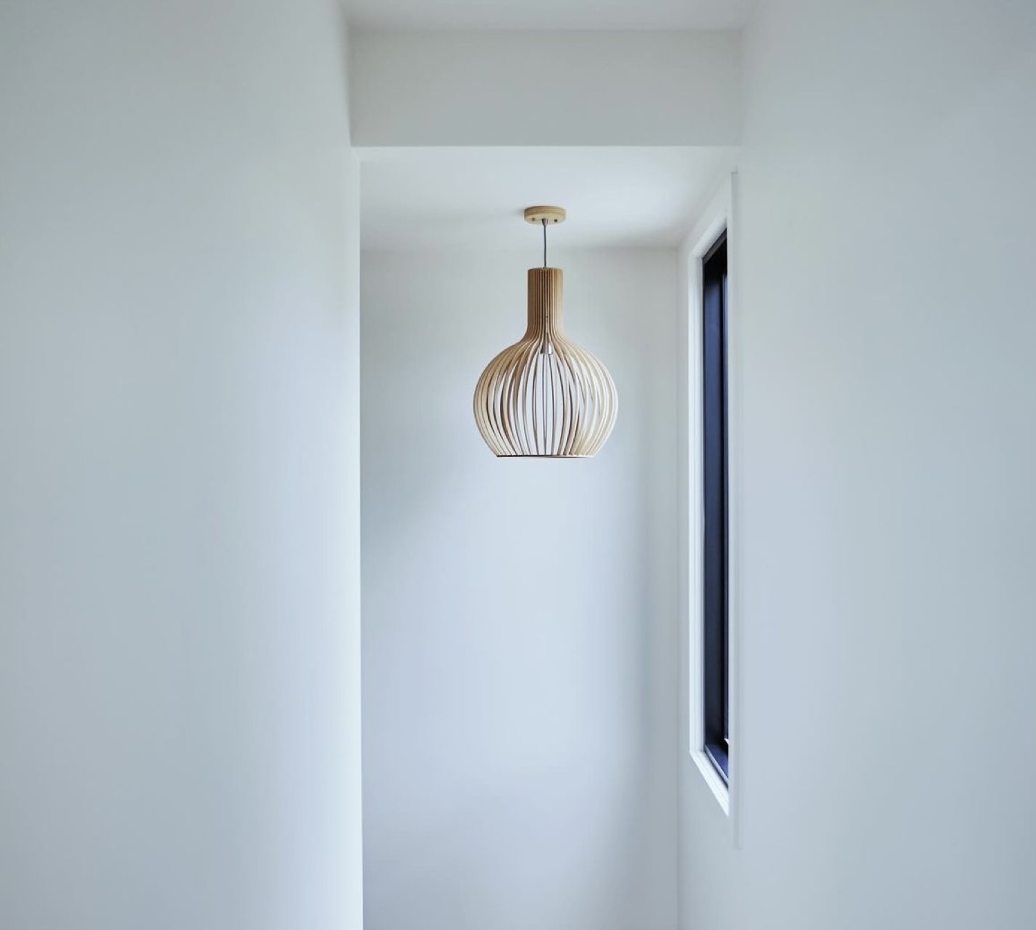 A pendant light hanging in a stairwell
