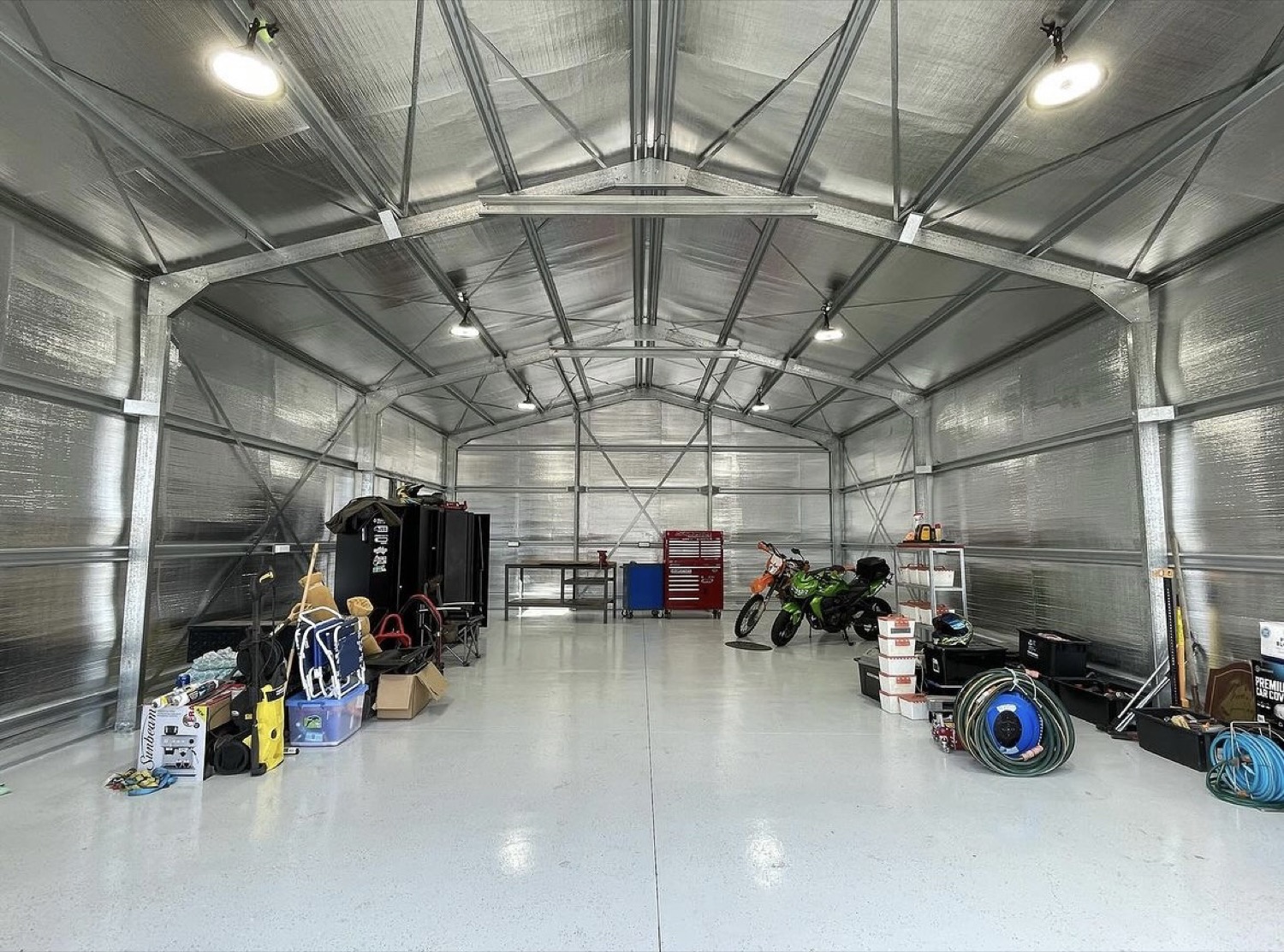 A large shed interior lit by rows of ceiling lights